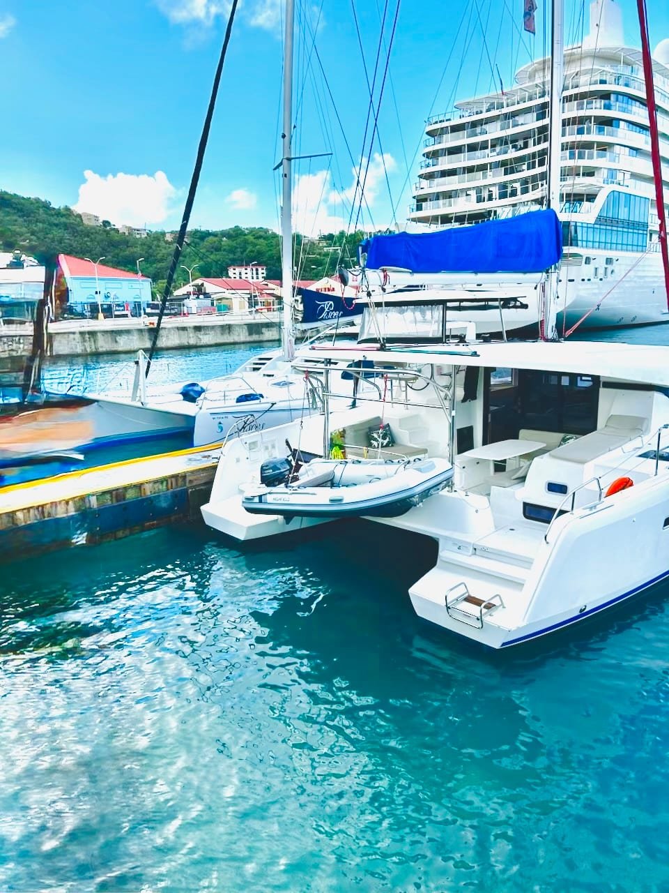 An Endless Blue catamaran at the WICO dock in Charlotte Amalie, guests stepping aboard just off the cruise pier
