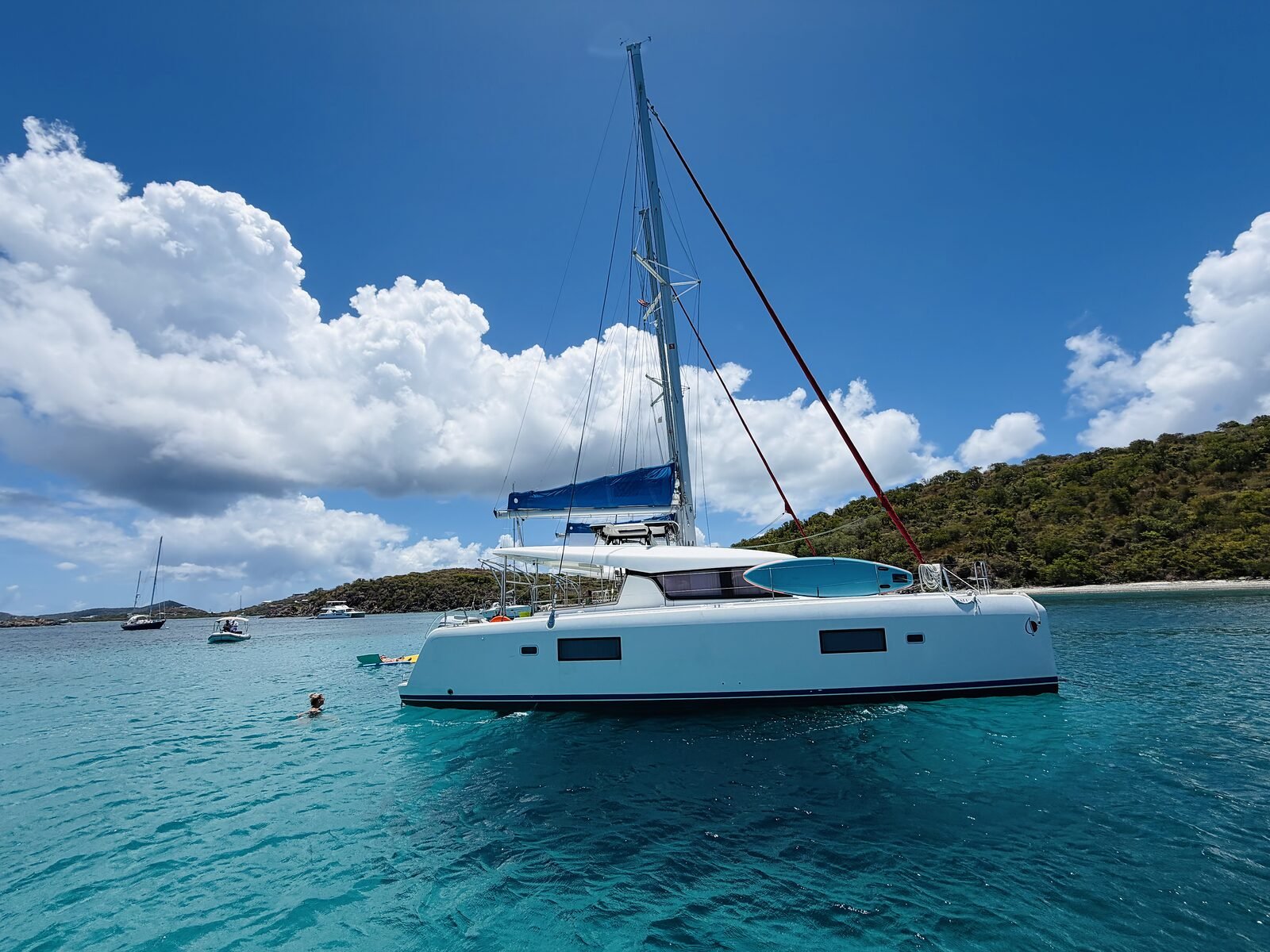 Bows of the rafted catamarans under dramatic Caribbean cumulus clouds