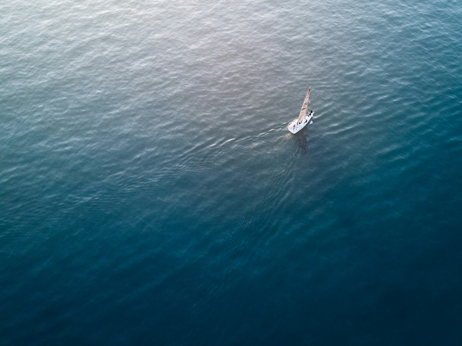 A lone sailboat on calm open water off the Virgin Islands