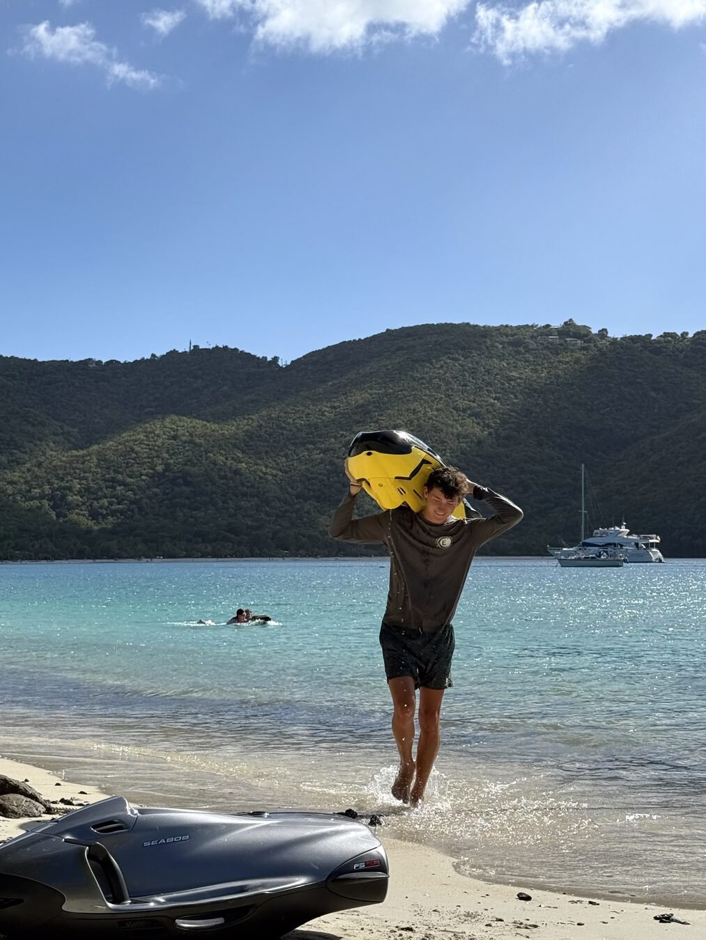 A guest launching off the catamaran into the water with a Sea Bob
