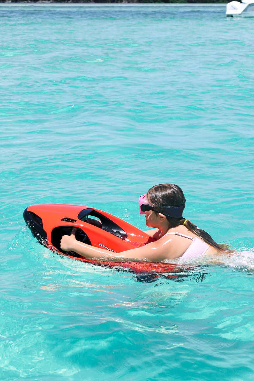 Sea Bob rider skimming along the clear water's surface